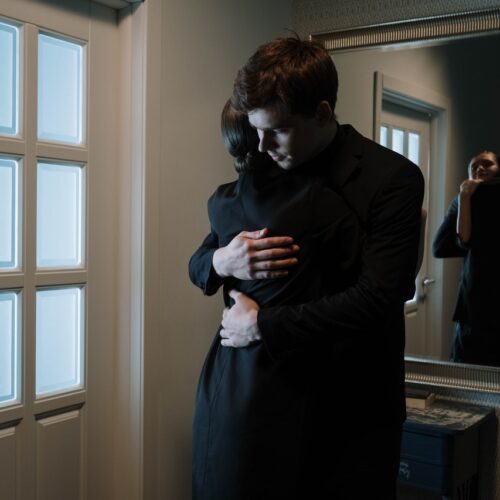 A grieving couple hugging