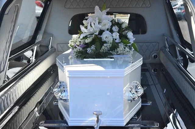 White coffin in a hearse
