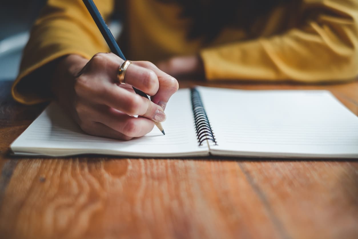 Person writing down a eulogy