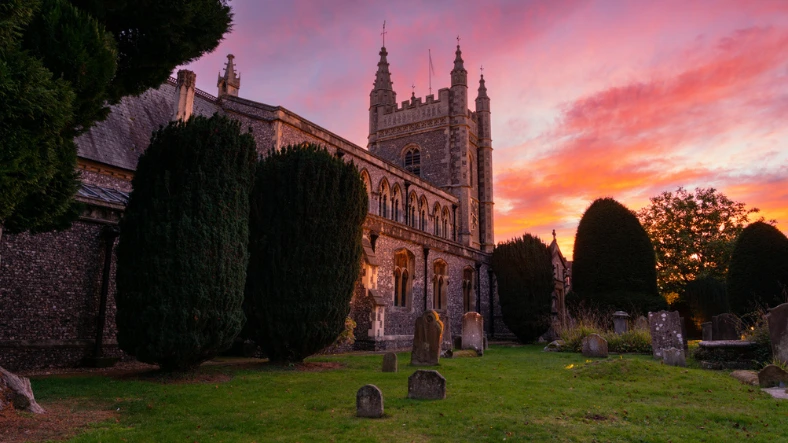 Direct burial. An image of a church with gravestones.