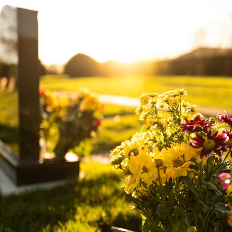non-religious funerals, a grave with flowers